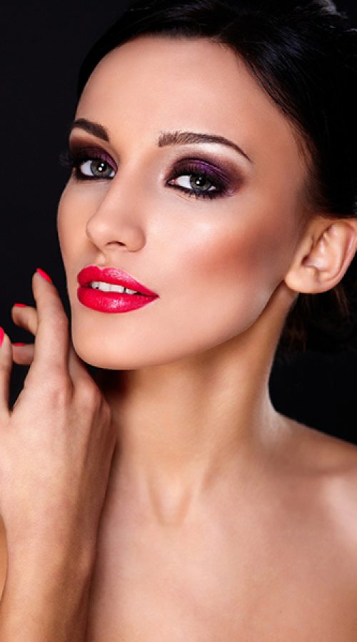 High fashion look.glamor closeup portrait of beautiful sexy Caucasian young woman model with red lips,bright makeup, with perfect clean skin isolated on black